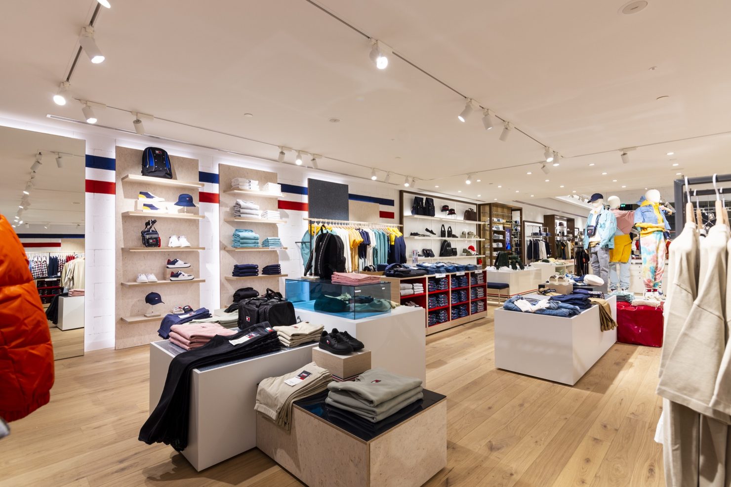 Retail floor with cork-faced wall shelving, display plinths and mannequins