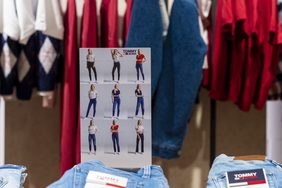 Printed size guide standing on a table of folded denim